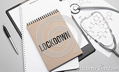 Inscription LOCKDOWN. Top view of the table with stethoscope,pen and medical documents. Health care concept Stock Photo