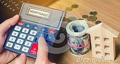 Inscription Mortgage on the calculator. The concept of calculating interest on a mortgage loan. Mortgage rates. Buying a home in Stock Photo