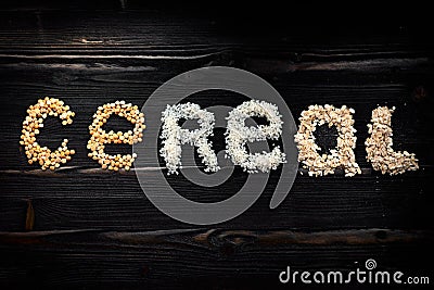 Inscription natural cereals grane and flakes on dark desk Stock Photo