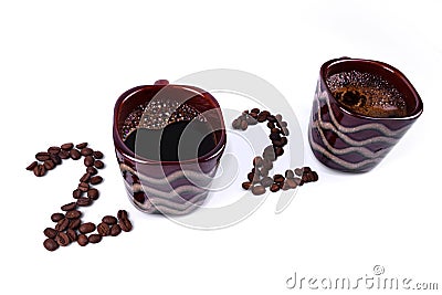 Inscription of 2020 number made of two cups of coffee and coffee beans laid out on white background Stock Photo