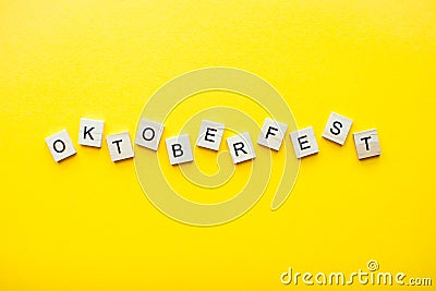 The inscription octoberfest from wooden blocks on a bright yellow background Stock Photo