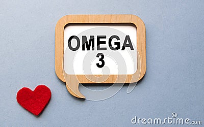 The inscription OMEGA 3 on a wooden template, against the background of scattered a red heart. Medical concept Stock Photo