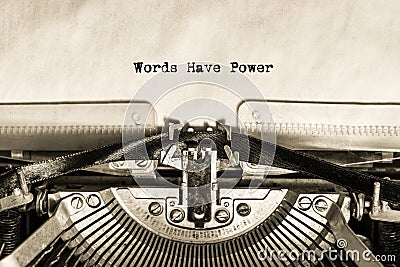 An inscription printed on a vintage typewriter on a piece of paper Words Have Power. Stock Photo