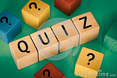 The inscription Quiz on wooden blocks other blocks with question marks, the concept of questions and answers in game shows and Stock Photo