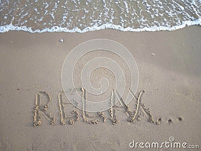 The inscription `Relax...` on a sandy beach Stock Photo