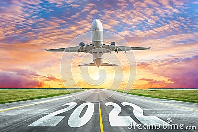 The inscription on the runway 2022 surface of the airport runway with take off airplane. Concept of travel in the new year, Stock Photo