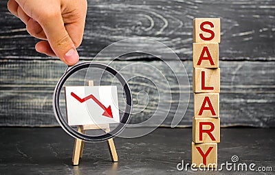 The inscription `salary` and the red arrow down. lower salary, wage rates. demotion, career decline. lowering the standard of livi Stock Photo