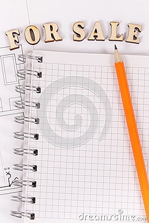 Inscription for sale and notepad on electrical diagrams, selling and buying house or flat concept Stock Photo