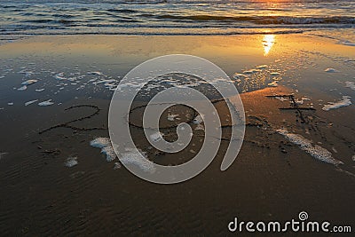 Inscription 2017 on a sandy beach during sunset Stock Photo
