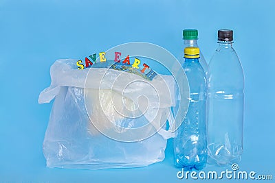 inscription SAVE EARTH, plastic bottles, abstract earth in polyethylene bag, blue background. Concept Stock Photo