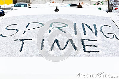 inscription on the snow-covered rear window of the car spring time on a bright sunny day. close-up Stock Photo