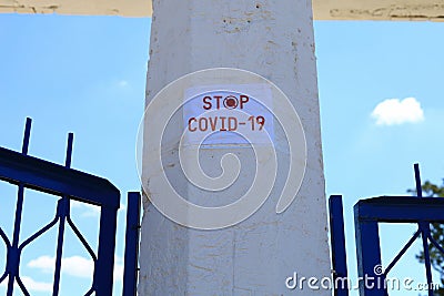 The inscription stop covid-19 on the column of the quarantined stadium Stock Photo
