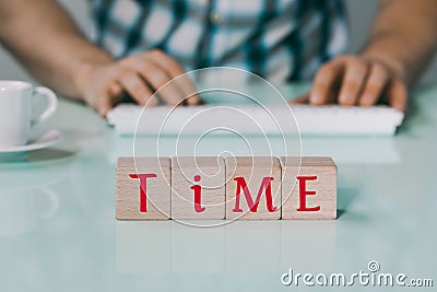 The inscription Time on wooden blocks, Background, Man typing on the keyboard, a cup of coffee, creative concept, Completion time Stock Photo