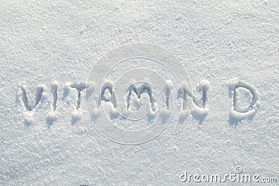 Inscription vitamin D on clean snow, in the bright rays of the winter sun. Health concept. Copy space. Stock Photo