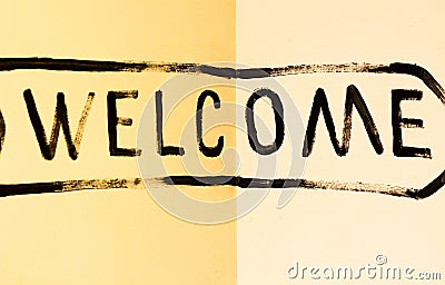 The inscription `Welcome` in black paint Stock Photo