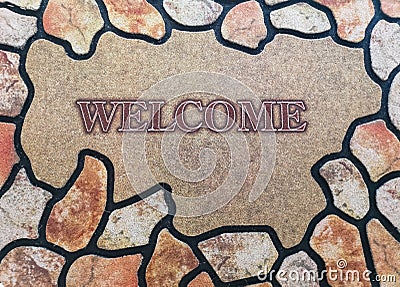 The inscription welcome to the center on the background of the pattern of stones with a brown and yellow tint Stock Photo