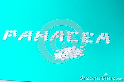 The inscription "Panacea" made of pills on a green background Stock Photo