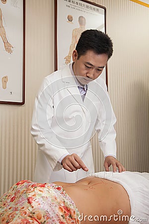 Inserting Acupuncture Needles Stock Photo