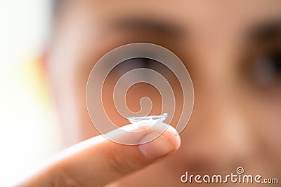 Inserting Contact Lens In Eye Stock Photo