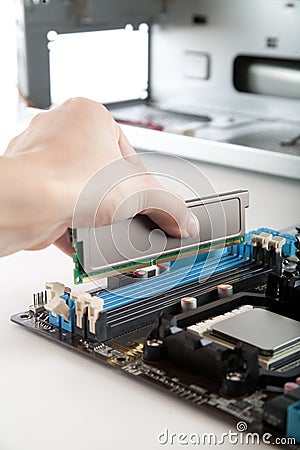 Inserting DDR 3 memory in the socket Stock Photo