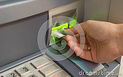 Inserting plastic card visa into ATM Stock Photo