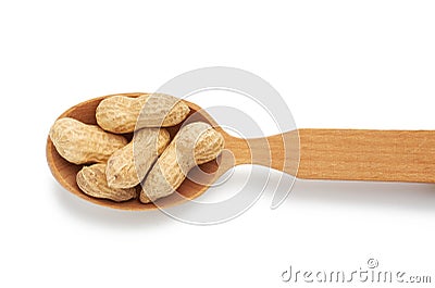 Inshell peanuts lies in a wooden spoon, tasty fruit is isolated on a white background Stock Photo