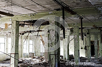 Abandoned and dangerous production premise with trash on floor. Stock Photo