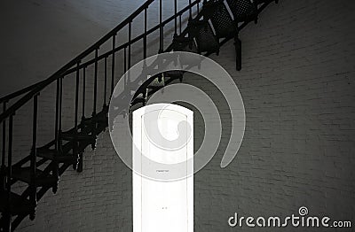 Inside of a Brick Lighthouse with Window and Curved Stairway Stock Photo