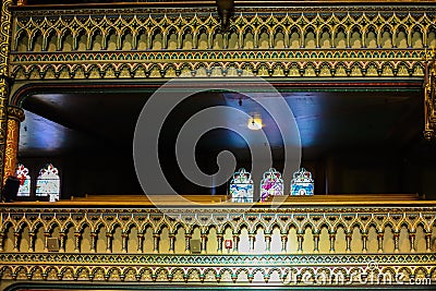 Inside the Catholic church is an altar with icons and lamps. organ, ancient decoration, Gothic, stained glass windows, columns. Stock Photo