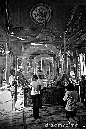 Inside of Chinese temple with a prayers. Editorial Stock Photo