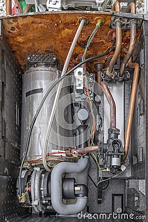 The inside of a condensing boiler completely devastated by rust and limescale, due to the hardness of the water Stock Photo