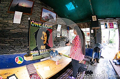 Inside fisheye shot with gopro of a colorful hillside cafe showing people relaxing eating drinking on the way to a Editorial Stock Photo