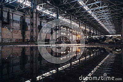 Inside of flooded dirty abandoned ruined industrial building with water reflection Stock Photo