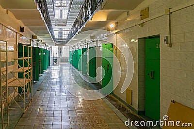 Inside of former old hundred years prison - view to corridor with prisoners cameras Editorial Stock Photo