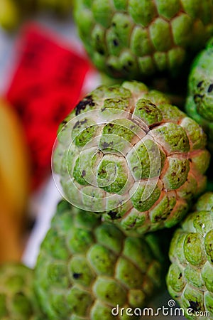 Fruit sugar apple on the counter of the fruit market. Fruits sugar-apple the size of a large apple, green, knobby. Stock Photo