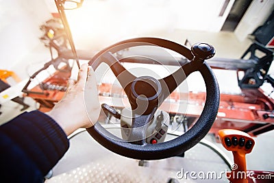 Inside harvester tractor. Steering wheel. View from work place Stock Photo