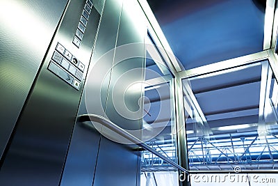 Inside metal and glass Elevator in modern building , the shiny buttons and railings Stock Photo