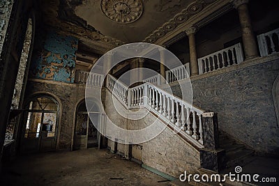 Inside of old creepy abandoned mansion. Staircase and colonnade Stock Photo