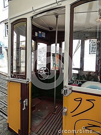 The inside of an old historic yellow tram with graffiti in Lisbon Editorial Stock Photo