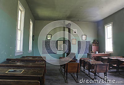 Inside One Room Schoolhouse Desks and Wood Stove Stock Photo