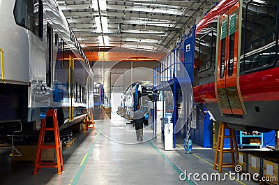 Inside of the rail car assembly plant `Stadler`. Industrial workshop for the production of high speed trains. Factory of the Editorial Stock Photo