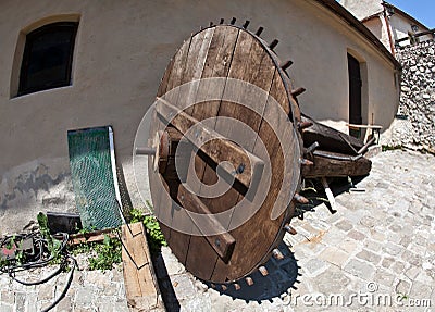 Inside Rasnov fortress, Transylvania - big wheel in a yard Stock Photo