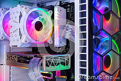 Inside view of custom colorful illuminated bright rainbow RGB LED gaming pc. Computer power hardware and technology concept Stock Photo