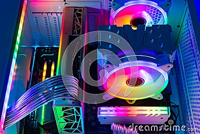 Inside view of custom colorful illuminated bright rainbow RGB LED gaming pc. Computer power hardware and technology concept Stock Photo