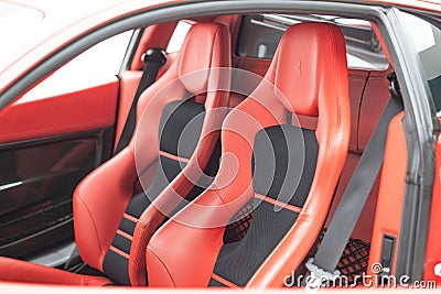 Inside view of a luxury red Ferrari 430 Scuderia sports car, with a modern red leather interior Editorial Stock Photo