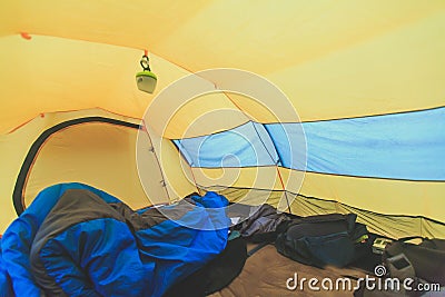 An inside view of tent, process of camping in fall or spring forest field, setting a tent covered Stock Photo