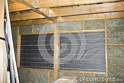 Inside wall heat isolation with mineral wool in wooden house, building under construction Stock Photo