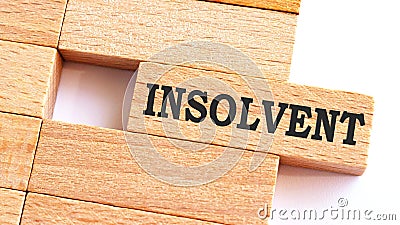INSOLVENT word written on wood block. INSOLVENT text on table, concept.Business photo text make something more modern or up to Stock Photo