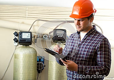 Inspector checking work of factory equipment Stock Photo