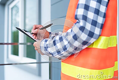 The inspector or engineer is checking the building structure and house roof specifications. After the renovate is complete Stock Photo